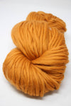 Cascade Yarns Magnum bulky yarn in honey ginger color, showing thick, textured wool yarn for knitting or crochet projects.