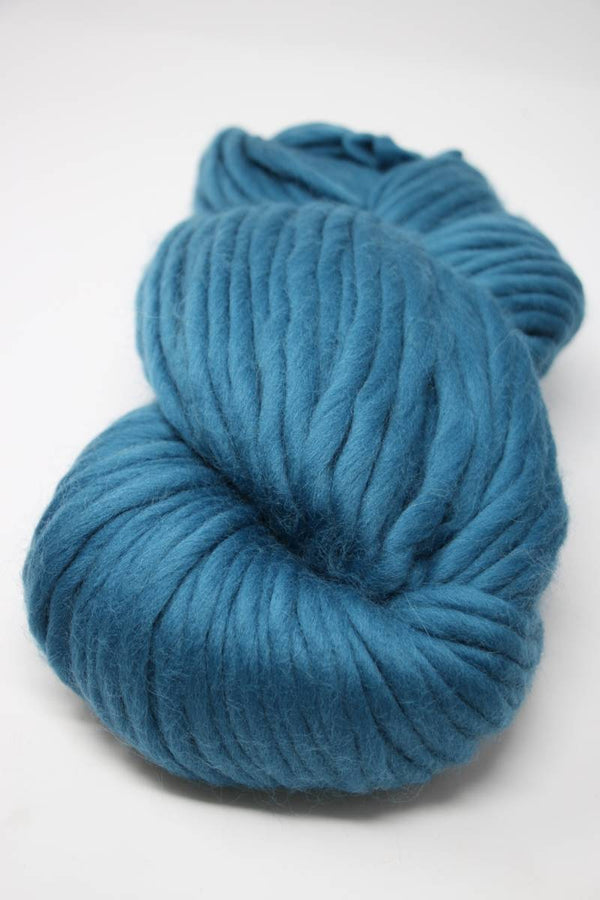 Cascade Yarns Magnum bulky yarn in celestial tea color, showing thick, soft yarn skein with vibrant teal and blue tones.