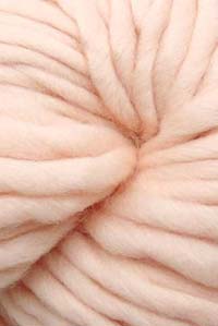 Cascade Yarns Magnum bulky yarn in Peach Dust color, showing thick, soft yarn strands suitable for cozy knitting projects.