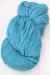 Close-up of Cascade Yarns Magnum bulky yarn in a skein, showcasing thick, soft, and textured yarn for knitting or crochet projects.
