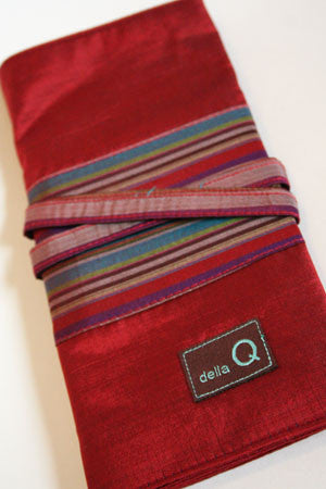 Della Q interchangeable needle case in red holding knitting needles and accessories, compact and organized.