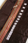 Della Q interchangeable needle case holding multiple knitting needles in black with clear compartments for organization.