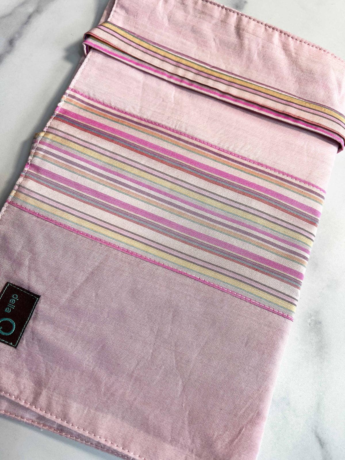 Della Q double point knitting needle case in pink and white stripes, designed to organize and protect knitting needles.