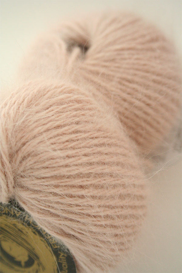 Galler Yarn Belangor French Angora yarn in natural cream color, soft and fluffy angora fiber close-up shot.