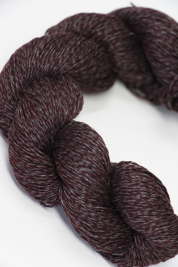 Jade Sapphire Sylph linen and cashmere yarn in a soft prune color, showcasing smooth, twisted fibers ready for knitting or knitting projects.