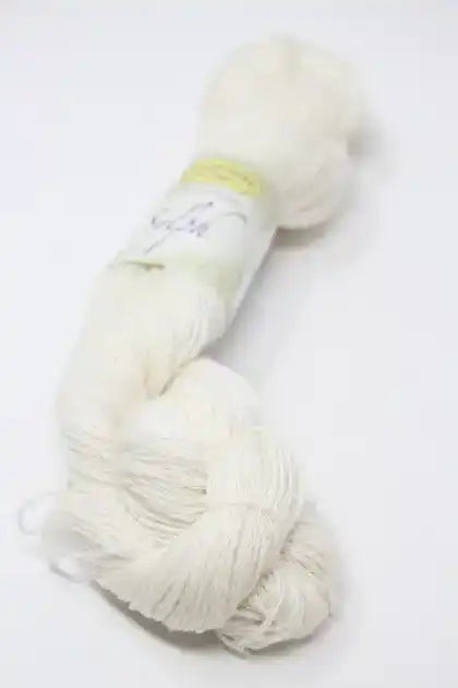 Close-up of Jade Sapphire Sylph linen and cashmere yarn showcasing soft, lightweight fiber in natural cream color.