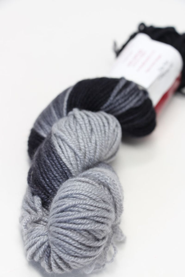 Close-up of black Jade Sapphire Zageo 6 Ply Cashmere yarn spool showing smooth, soft cashmere fibers and detailed label.