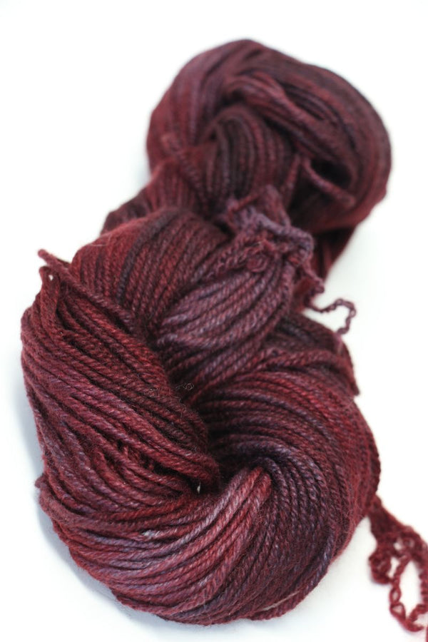 Red Jade Sapphire Zageo 6 Ply Cashmere yarn in a close-up view, showcasing soft, luxurious cashmere fibers and rich color.