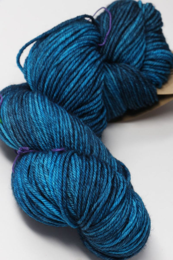 Madelinetosh Tosh DK yarn in Baltic colorway, soft and vibrant wool and silk blend for knitting or crochet projects.