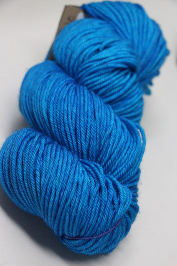 Blue Nelie Madelinetosh Tosh DK yarn ball showing soft wool texture and vibrant color for knitting or crochet projects.