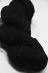 Madelinetosh Tosh DK yarn in Onyx color, showcasing soft, twisted skein of rich black wool for knitting or crocheting projects.