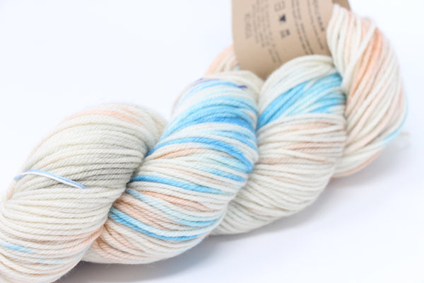 Madelinetosh Tosh DK yarn in Seasalt color, soft and plump skein of medium-weight wool and silk blend for knitting projects.