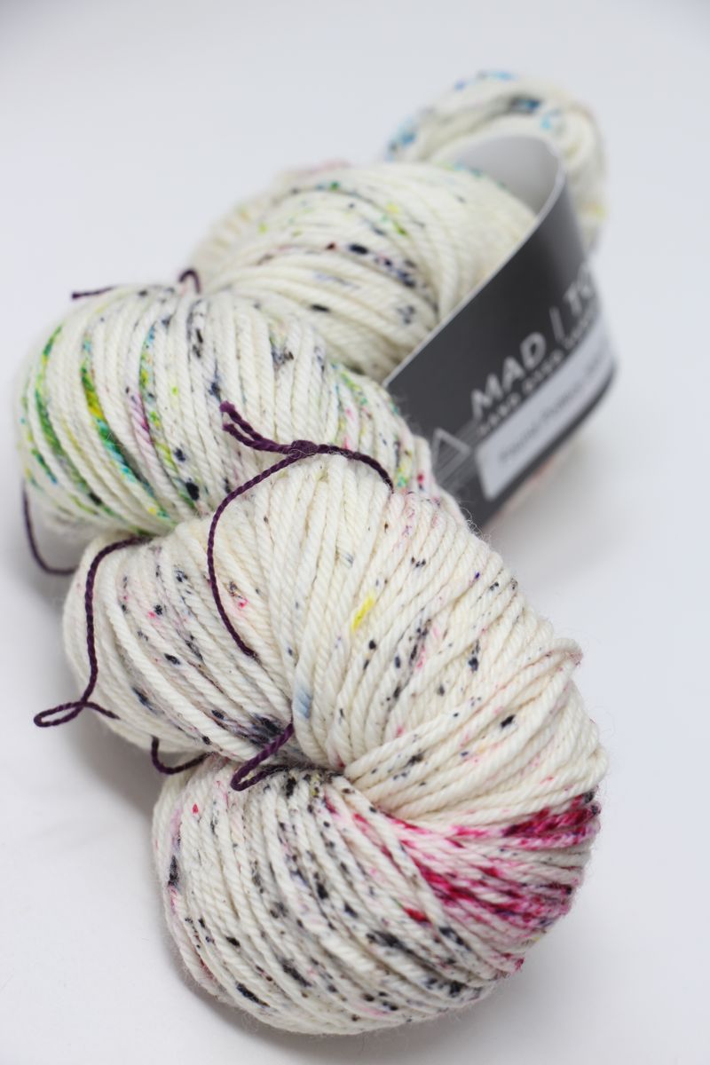 Madelinetosh Tosh DK yarn in a rich, earthy colorway, showing a close-up of the soft, twisted wool fiber suitable for knitting and crochet.