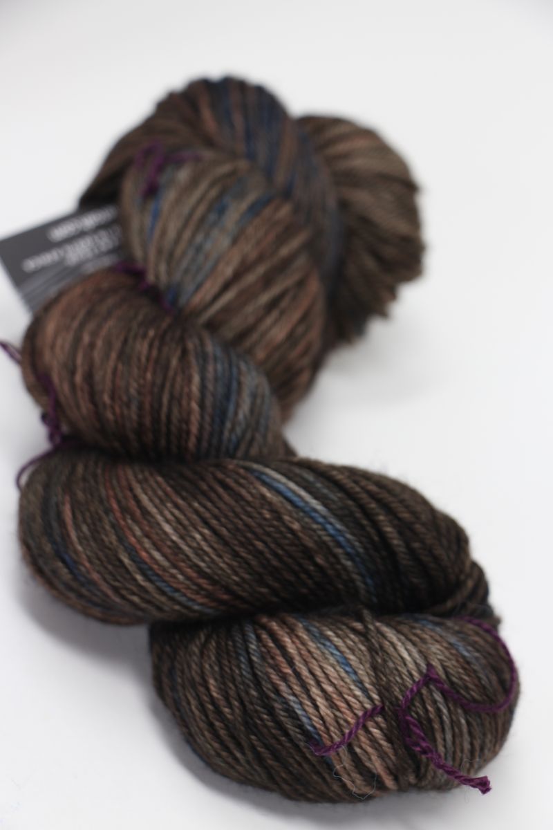 Madelinetosh Tosh DK yarn in Whiskey Barrel color, soft wool blend shown in close-up, ideal for knitting and crochet projects.