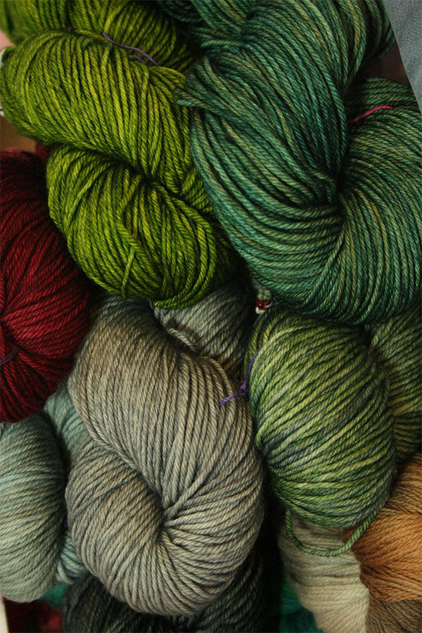 Soft Madelinetosh Tosh DK yarn in vibrant colors, displayed in a close-up shot showing its texture and rich fiber quality.