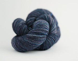 Madelinetosh Tosh DK yarn in rich, variegated shades, showcasing the soft, twisted skein of this popular DK weight yarn.
