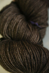 Madelinetosh Tosh DK yarn in Pecan Hull color, showcasing a close-up of soft, hand-dyed wool yarn for knitting or crochet projects.