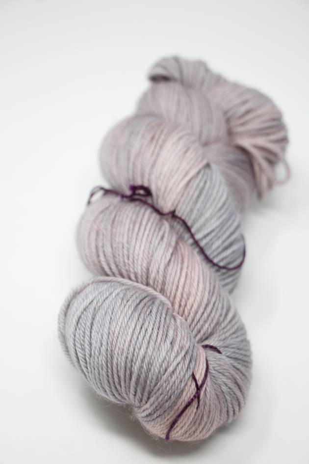Madelinetosh Tosh DK yarn in Calligraphy colorway, showcasing soft, hand-dyed wool in a close-up image.