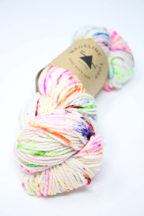 Madelinetosh Tosh DK yarn in vibrant Holi Festival colorway, showing soft, hand-dyed wool yarn with rich, multicolored tones.