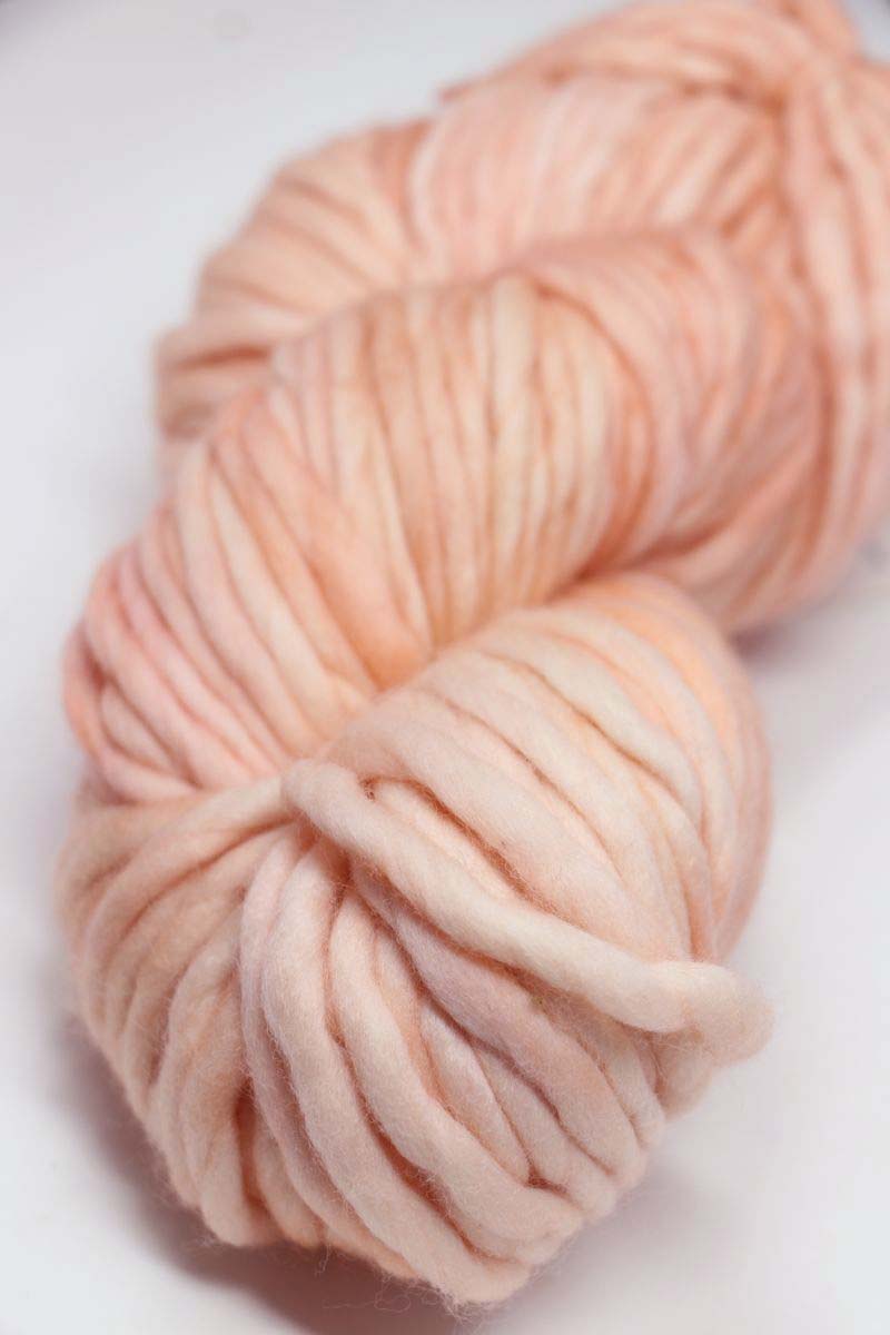 Malabrigo Rasta merino wool yarn in melon color, showcasing thick, soft, and vibrant hand-dyeing for knitting and crochet projects.