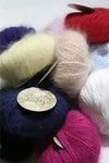 Cream Plymouth Angora Yarn skeins with soft, fluffy texture, perfect for knitting cozy garments and accessories.