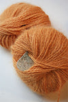 Pink Plymouth Angora Yarn ball with soft, fluffy texture, perfect for knitting cozy garments and accessories.
