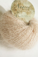 Plymouth Angora Yarn in sand color, showing soft, fluffy knitting yarn with a close-up of the textured fibers and gentle color.
