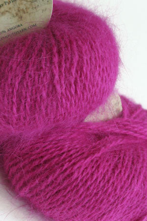 Plymouth Angora Yarn in soft berry color, close-up of the plush, fuzzy knitting yarn with a twisted strand showing texture and ply.