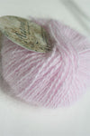Soft pink Plymouth Angora Yarn skein showcasing fluffy texture and vibrant color, ideal for knitting projects.