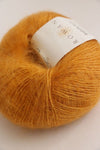 Rowan Kidsilk Haze yarn in vibrant orange color, showcasing soft, delicate fibers suitable for knitting or crochet projects.