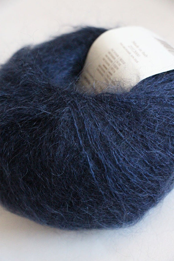 Rowan Kidsilk Haze yarn in Turkish Plum color, showing soft, delicate fibers ideal for knitting or crochet projects.