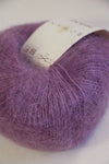 Soft, pink Rowan Kidsilk Haze yarn ball featuring a delicate, lightweight blend of silk and mohair fibers.