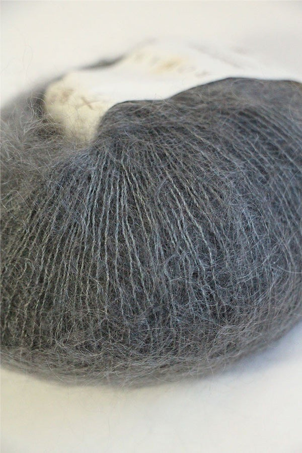 Soft, lightweight Rowan Kidsilk Haze yarn in a smoky gray color, perfect for knitting delicate scarves and shawls.