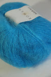 Close-up of Rowan Kidsilk Haze yarn in Atlantic color, showcasing soft, delicate fibers ideal for knitting and crochet projects.