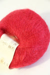 Rowan Kidsilk Haze yarn in strawberry pink, soft and delicate with a smooth texture, ideal for knitting and crochet projects.