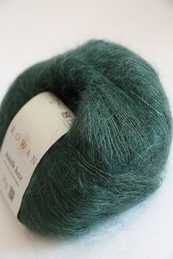 Soft, forest green Rowan Kidsilk Haze yarn ball showcasing its delicate, lightweight silk and mohair blend texture.