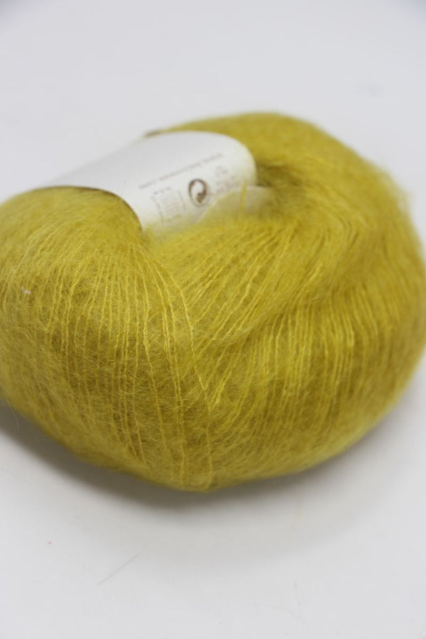 Rowan Kidsilk Haze yarn ball in eve green color, soft and lightweight blended silk and mohair for knitting or crochet projects.