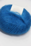 Soft Rowan Kidsilk Haze yarn in Laguna color, showcasing delicate, lightweight fiber ideal for knitting and crochet projects.