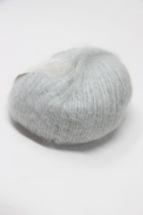 Soft, multicolored Rowan Kidsilk Haze yarn skein in pastel shades, ideal for knitting and crochet projects.