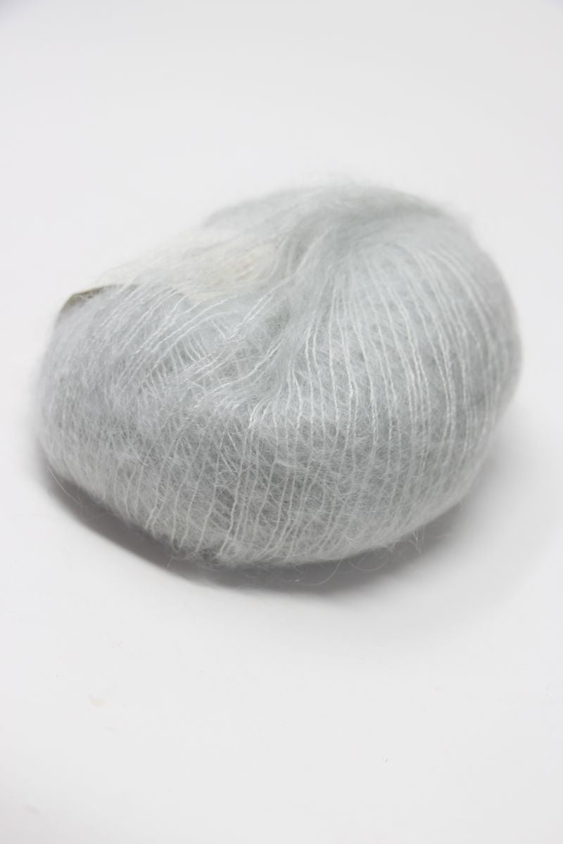 Soft, multicolored Rowan Kidsilk Haze yarn skein in pastel shades, ideal for knitting and crochet projects.