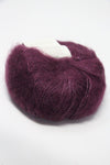 Multicolored Rowan Kidsilk Haze yarn skein in soft pink, purple, and beige tones, ideal for delicate knitting and crochet projects.