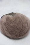 Soft Rowan Kidsilk Haze yarn in a natural branch color, showcasing its delicate, lightweight texture ideal for knitting and crochet projects.