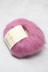 Soft, multicolored Rowan Kidsilk Haze yarn in a cozy skein, showcasing its delicate, shimmering texture and vibrant hues.