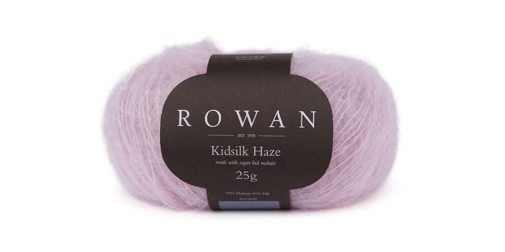Soft Rowan Kidsilk Haze yarn in a vibrant lilac color, showcasing delicate, lightweight fibers ideal for knitting and crochet projects.