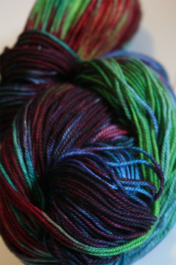Fingering weight yarn Serenity 20 by Zen Yarn Garden in soft, variegated shades, displayed in a close-up shot.