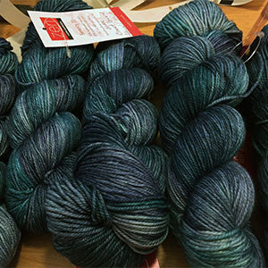 Fingering weight yarn from Zen Yarn Garden's Serenity 20 collection in soft coastal blue and beige tones.