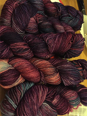 Fingering weight yarn from Zen Yarn Garden's Serenity 20 collection in a vibrant jazzberry color, showcasing soft, smooth fiber.