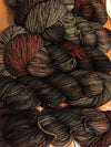 Fingering weight yarn in mahogany color from Zen Yarn Garden's Serenity 20 collection, showcasing soft, variegated fibers.