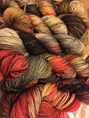 Fingering weight yarn from Zen Yarn Garden's Serenity 20 collection in a colorful, variegated skein with shades of blue, green, and purple.