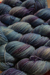 Fingering weight yarn Zen Yarn Garden Serenity 20 in blurple color, showing soft, variegated purple and blue tones.